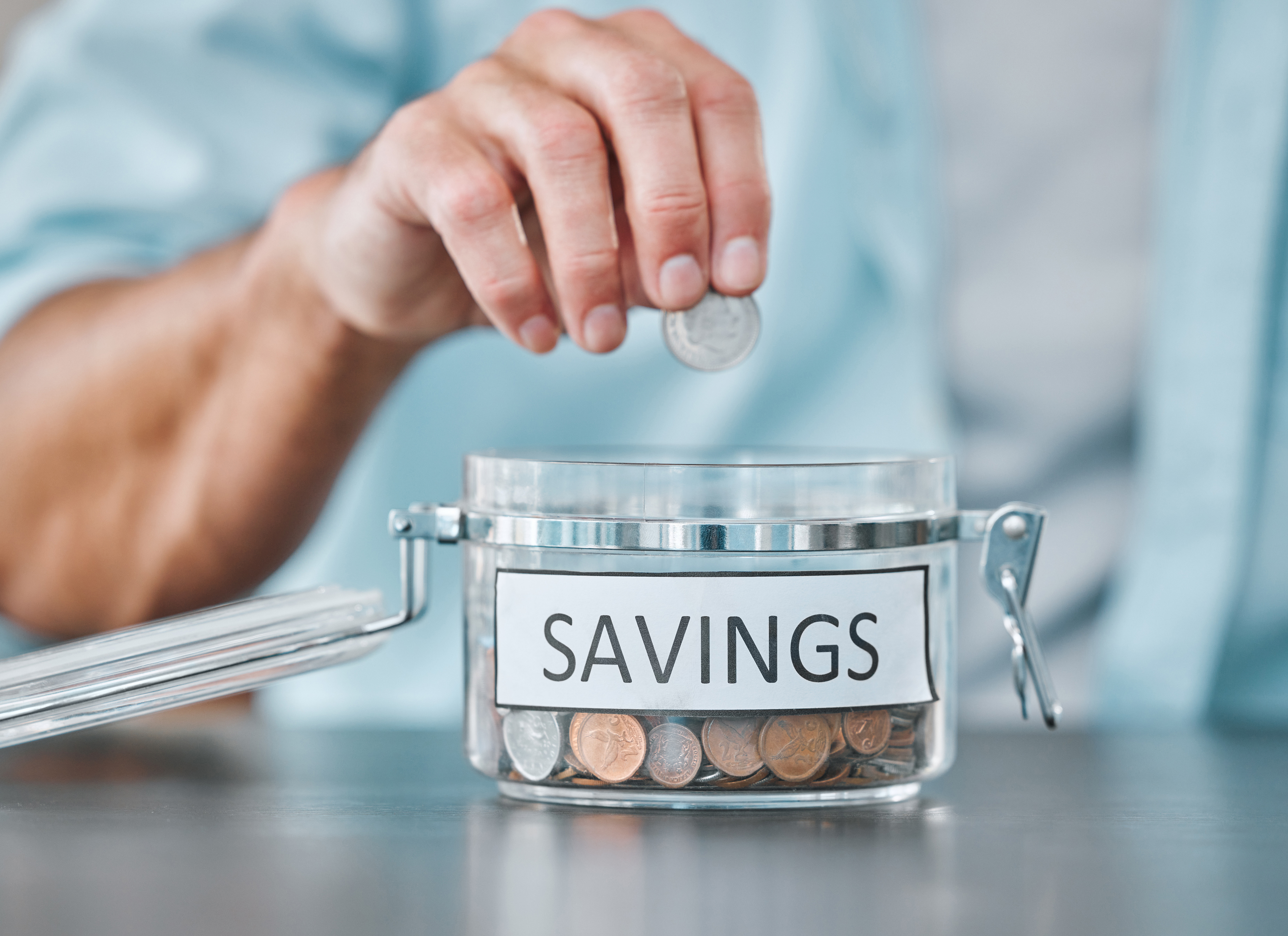 putting coins in savings jar